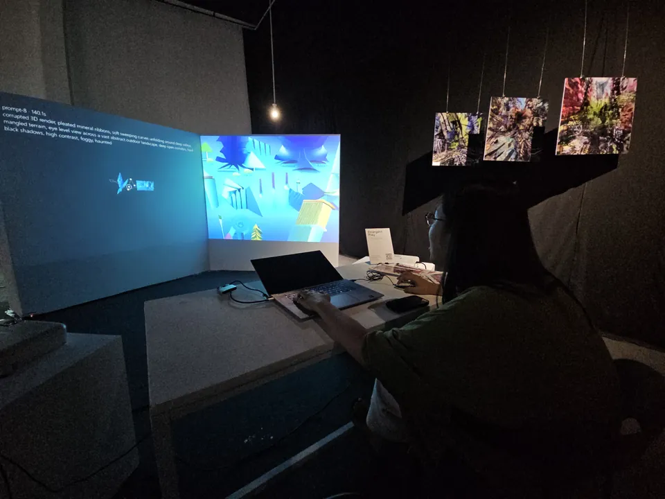 A visitor seated at the game controls facing the projected landscape.